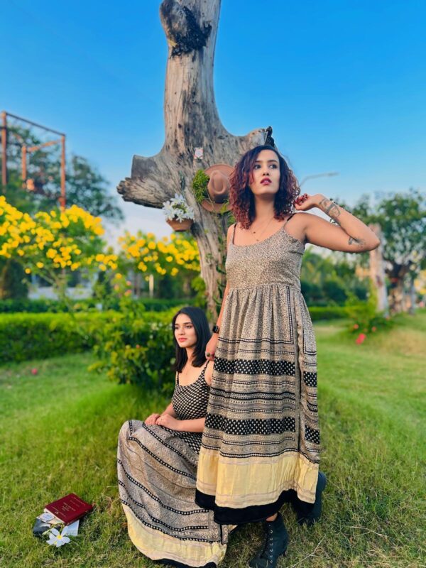 Founder of Secrets of the East Scarlett Pragya wearing a boho silk dress Kali Gold Lux Maxi standing in nature. Divine feminine luxury fashion designed in Australia